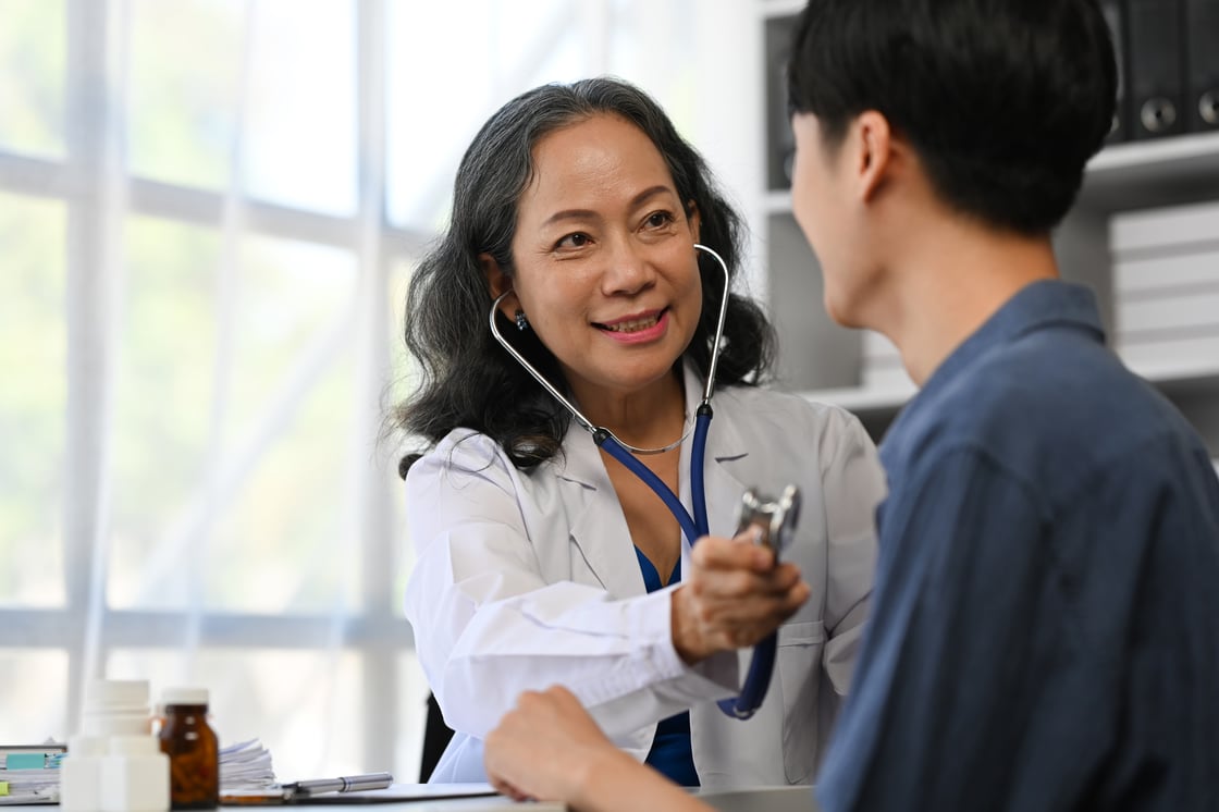 positive-mature-doctor-using-stethoscope-listenin-2023-11-27-05-08-43-utc