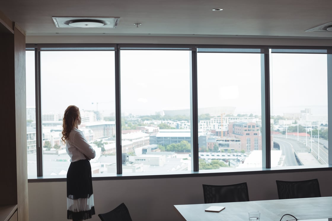 side-view-of-businesswoman-looking-out-through-gla-2023-11-27-05-10-53-utc